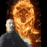 a man with a beard stands in front of a flaming lion