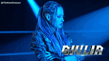 a woman with blue dreadlocks and the name giulia on the bottom