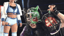 a female wrestler wearing a mask and holding a bag that says blow