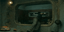 a man is laying on a bed in a room with a large window .