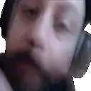 a man with a beard is wearing headphones and a hat .