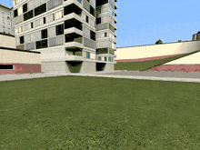 a large building with a lot of windows is surrounded by a lush green lawn