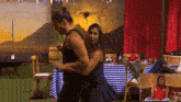 a man and a woman are dancing in a room
