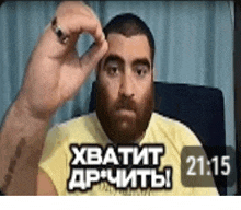 a man with a beard and a yellow shirt is giving a thumbs up .