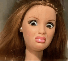 a close up of a doll making a face