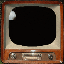 an old fashioned television with a black screen and a few buttons on it