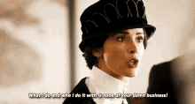 a woman wearing a hat and a white shirt is talking to someone .