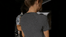 a man in a striped shirt is holding a woman in a striped shirt .