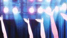 a group of people raising their hands in the air at a concert