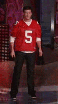 a man in a red jersey with the number 5