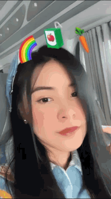 a girl wearing a headband with an apple juice box on top of her head