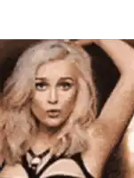 a close up of a woman 's face and arm .
