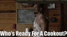 a man in an apron is standing in front of a chalkboard with the words who 's ready for a cookout on it