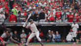 a baseball player getting ready to hit a ball in front of a crowd with a sign that says postseason on it