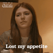 a woman sitting at a table with the words lost my appetite written on her face