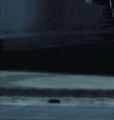 a person is standing in a dark room holding a sword