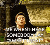 a man is standing in front of a statue and says `` me when i hear somebody say sweet treat ''