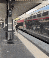 a man walking towards a train that has the number 41 on it