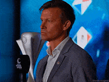 a man in a suit is standing in front of a microphone that says fox sports