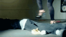 a woman in high heels is stepping on a man 's foot