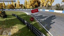 a stop sign is on the side of a road next to a fence