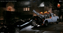 a tow truck is pulling a black car with the words rush hour on the screen