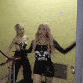 two women are standing on a set of stairs .