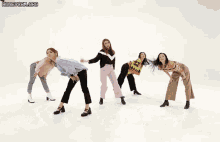a group of women are dancing in front of a white background with the words honeycam.org written on the bottom