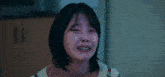 a woman is crying with tears running down her face while wearing a sweater .