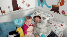 a boy and a girl are laying on a bed with a pillow that says ' little blue '