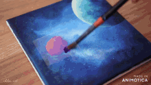 a painting of a planet is being painted on a canvas made by chloe art