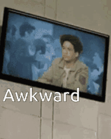 a picture of a man on a television screen with the word awkward below it