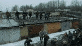 a group of people are standing on top of a garage