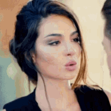 a close up of a woman 's face with her mouth open .