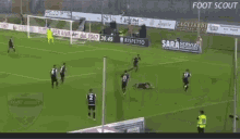 a soccer game is being played on a field with advertisements for turla and cagliardi