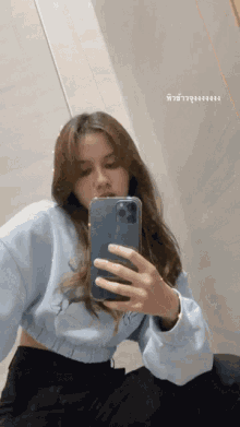 a woman is taking a picture of herself with her phone