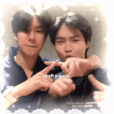 two young men are making a heart shape with their fingers and the words chofi y maca are on the bottom