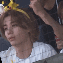 a person wearing a headband with a pikachu on top of it
