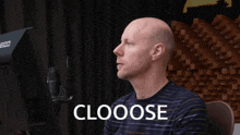 a man sitting in front of a computer with the word clooose on the screen