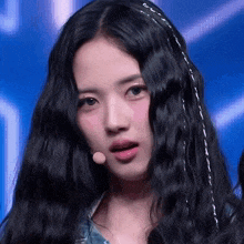 a close up of a woman with long black hair