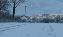 a truck is driving down a snow covered street