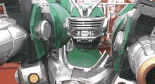 a close up of a green robot with a helmet on it .