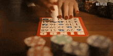 a person is playing bingo with a netflix logo in the corner