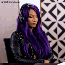 a woman with purple hair is wearing headphones and has the twitter account @mrsashabanks