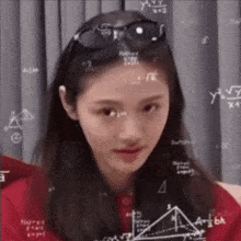 a woman wearing sunglasses and a red shirt is surrounded by mathematical equations