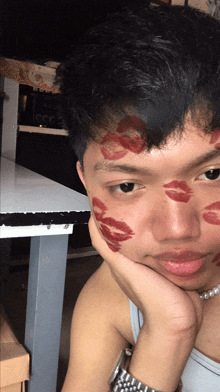 a young man with red lips on his face