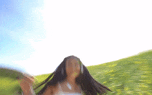 a woman in a white dress is standing in a field of tall grass