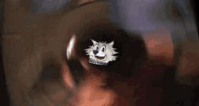 a cartoon cat 's face is visible through a hole in a pipe