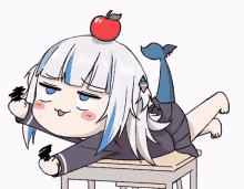 a cartoon girl with a fish tail is laying on a desk with an apple on her head .