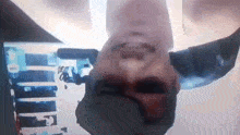 a close up of a man 's face with his head upside down